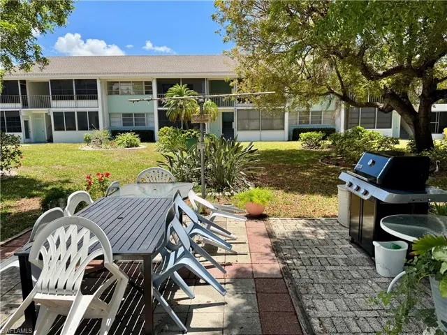 View of patio with grilling area and outdoor dining area
