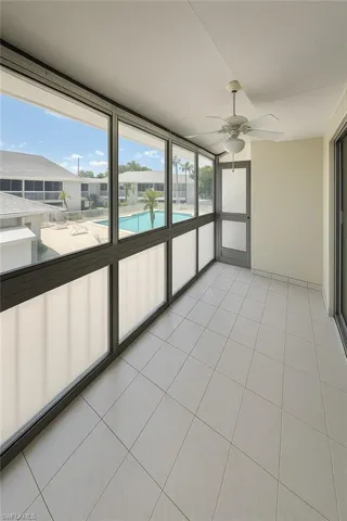 Unfurnished sunroom with tile patterned floors and floor to ceiling windows