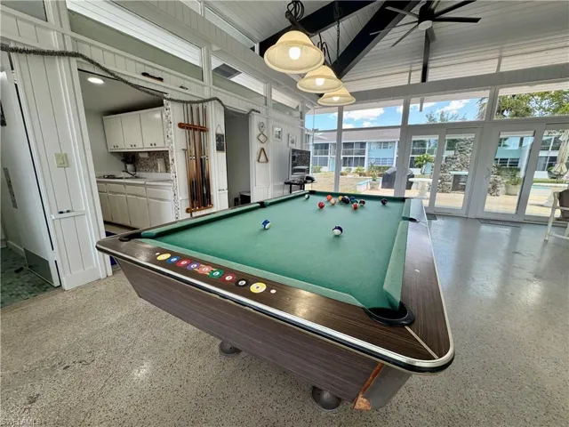 Game room featuring high vaulted ceiling, pool table, and beamed ceiling