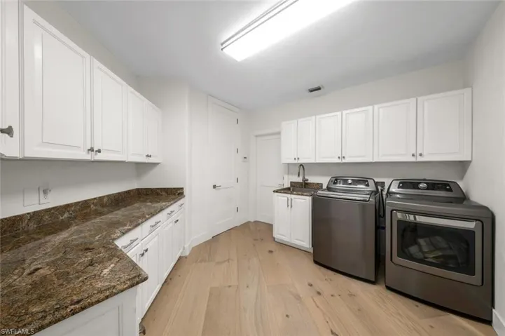 XL laundry room with lots of storage storage