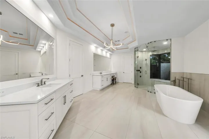 Primary bathroom with indoor/outdoor garden shower and standing tub
