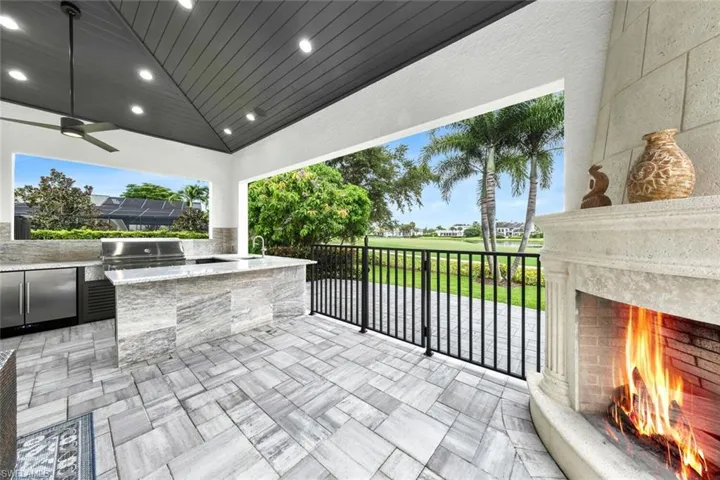 Outdoor grill, fireplace and additional patio, outside of the gate