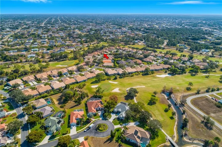 Aerial view of property's location with a local golf course