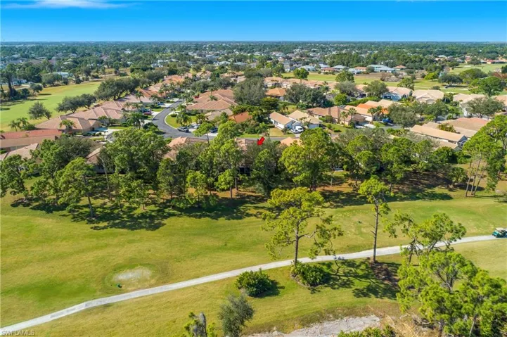 Aerial overview of property's location with a golf course