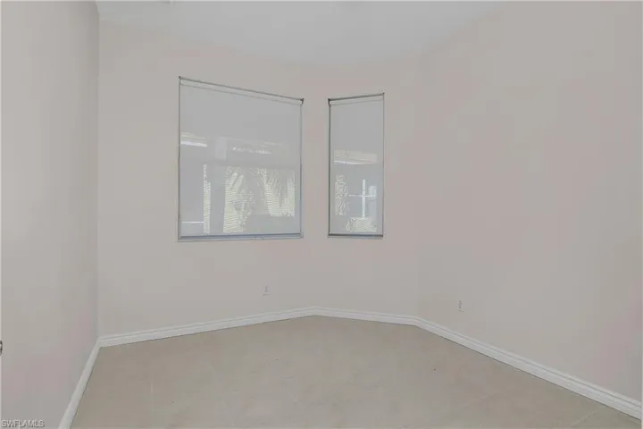 Third bedroom room featuring baseboards and light tile patterned floors