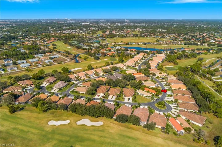 Aerial overview of property's location with a golf course