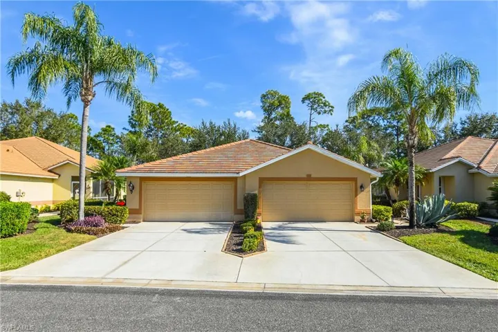 Ranch-style house with stucco siding, concrete driveway, a tile roof, a front lawn, and an attached garage