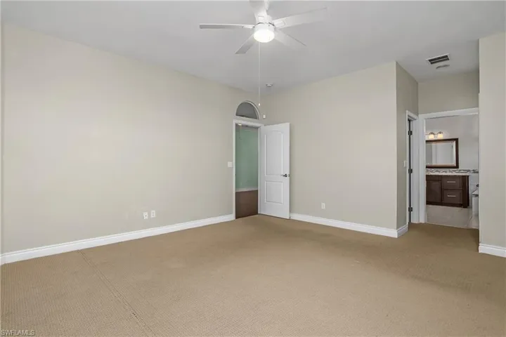 Primary bath featuring a bath, light tile patterned floors, vanity, walk in shower, decorative tile walls, and a chandelier