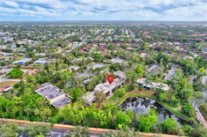 Birds eye view of property with a water view
