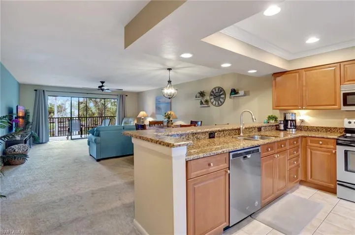 Kitchen featuring stainless  appliances, granite countertops and breakfast bar