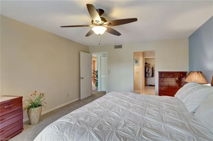 Carpeted bedroom featuring two spacious closets