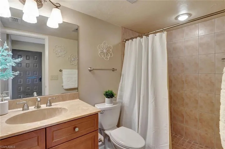Bathroom featuring vanity, toilet, and walk in shower