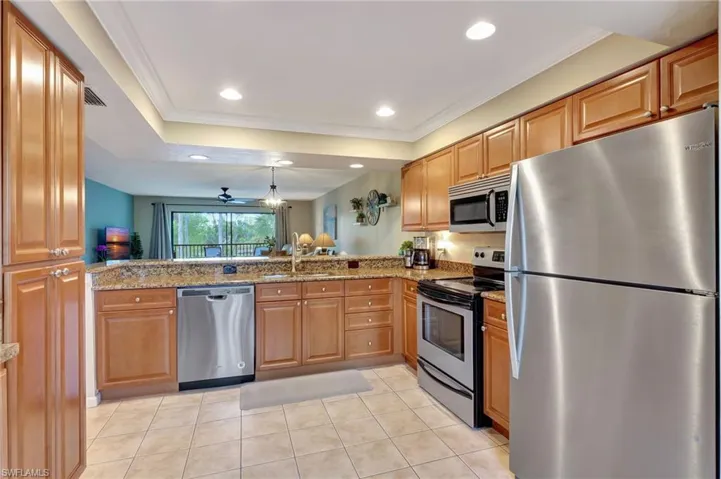 Kitchen with stainless steel appliances, granite counters, and kitchen peninsula