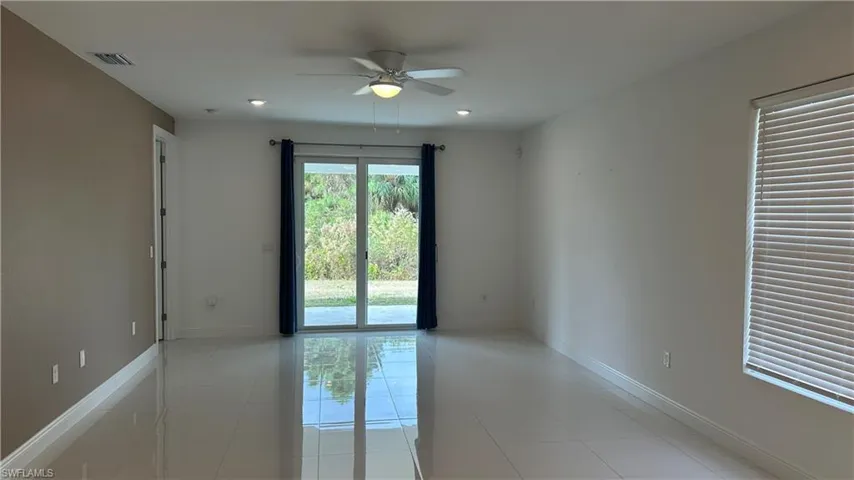 Spare room with ceiling fan, light tile patterned flooring, and recessed lighting