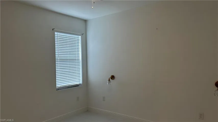 Unfurnished room featuring baseboards and light tile patterned floors