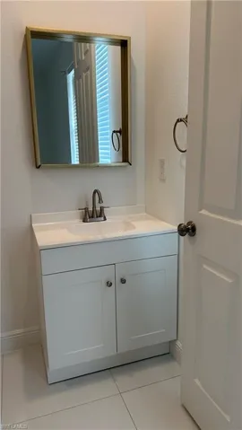 Bathroom with vanity and light tile patterned floors