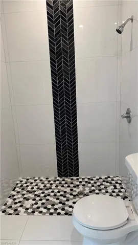 Full bath featuring a shower stall