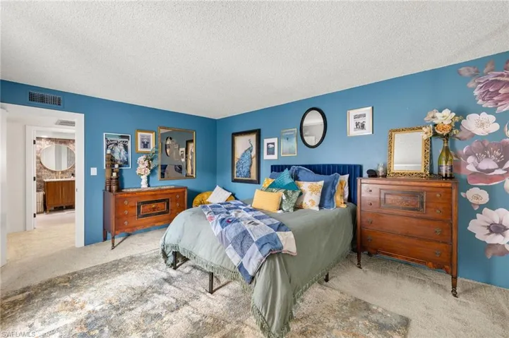 Carpeted bedroom featuring a textured ceiling
