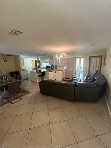 Living room with light tile patterned floors