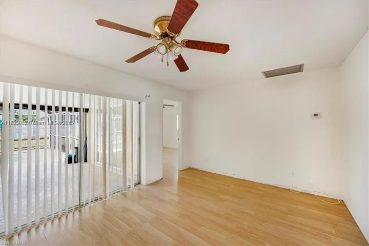 Empty room with light wood-style flooring and a ceiling fan