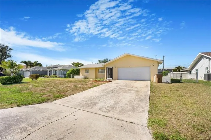 Ranch-style home featuring concrete driveway, stucco siding, and an attached garage