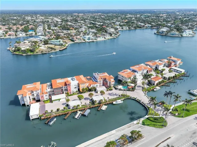 East facing aerial view of Venetian Villas with view of Doctors Bay, Park Shore, and the Moorings in the distance
