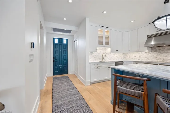 Front entryway with engineered wood flooring and recessed lighting