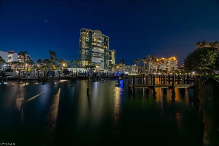 Northwest nighttime water view from community featuring beachfront residences and boat dock