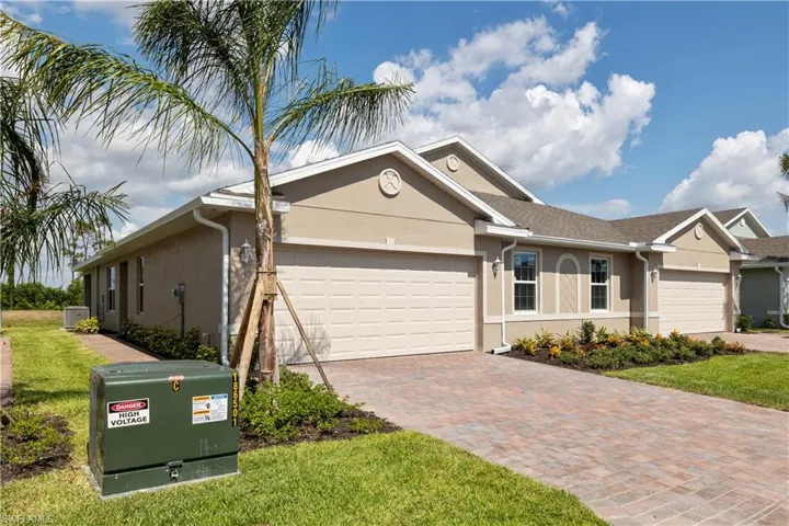 Ranch-style home featuring central AC, a garage, and a front yard