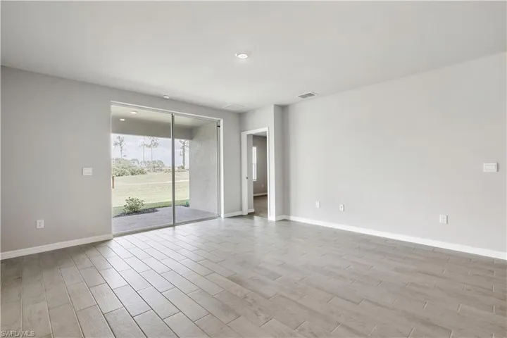 Empty room with light hardwood / wood-style flooring