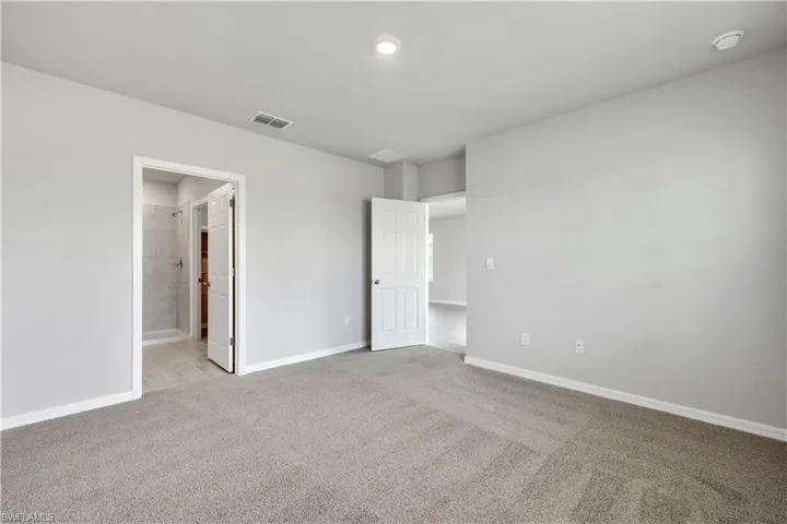 Empty room with light colored carpet