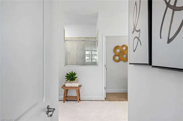 Hallway with baseboards and wood finished floors