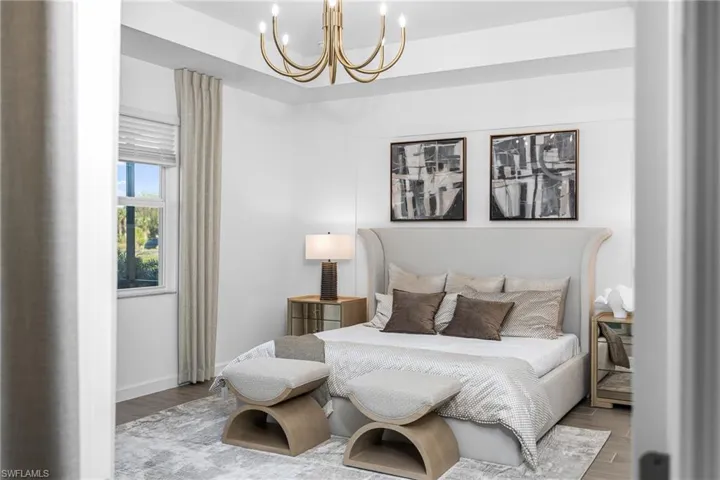 Bedroom featuring wood finished floors and a chandelier