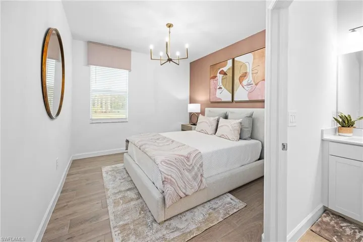Bedroom with light wood-style flooring and a chandelier