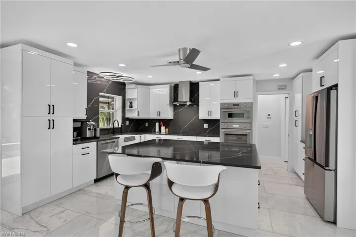 Quartz counters, backsplash, and huge island. Thermador wall oven, speed oven, and Freedom induction cooktop.