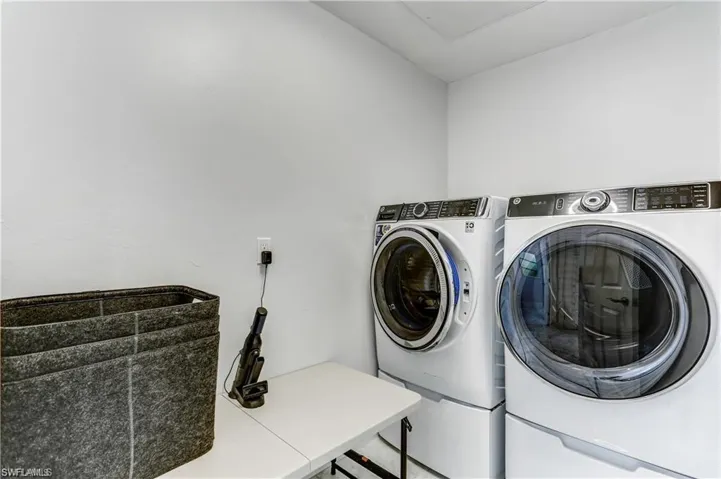 Separate laundry room with  G.E. elevated washer and dryer.