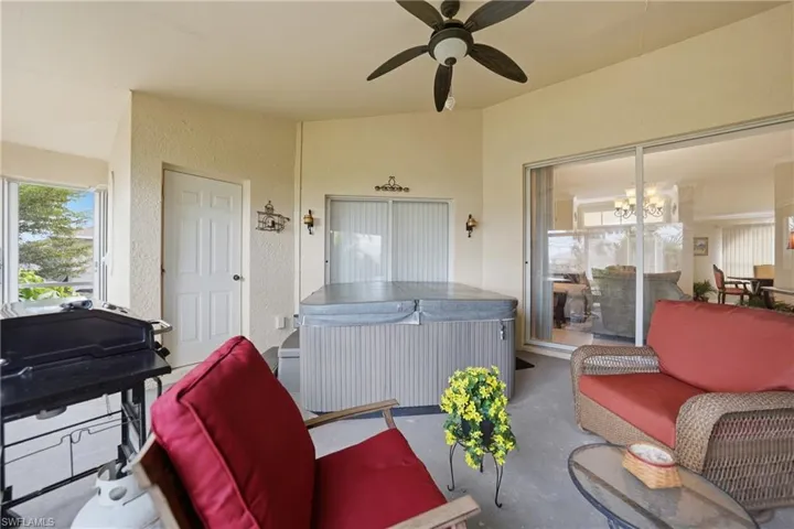 View of patio with a hot tub, a ceiling fan, and an outdoor hangout area