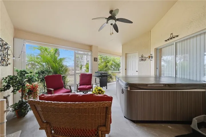 Sunroom featuring finished concrete floors, half bath and a jacuzzi