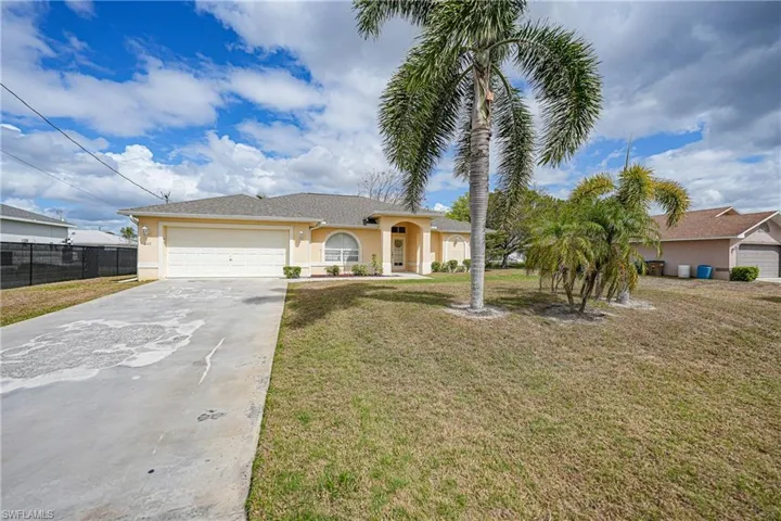 Single story home with stucco siding, concrete driveway, and an attached garage