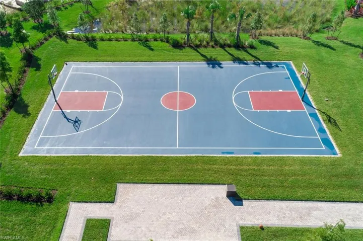 View of sport court featuring community basketball court and a lawn