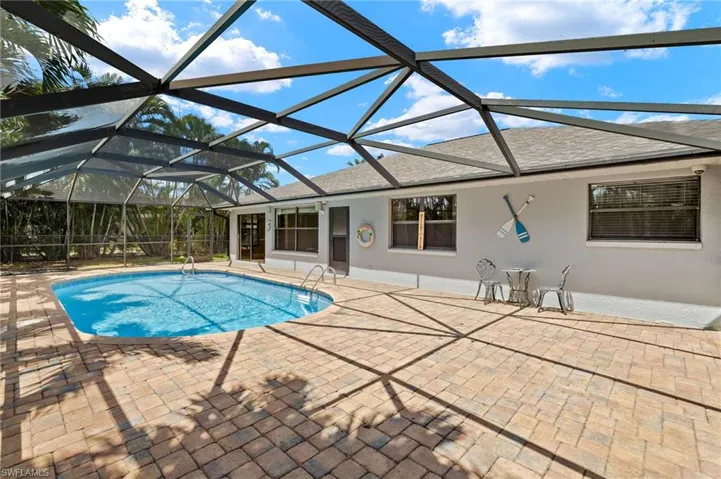 Outdoor pool featuring a patio and a lanai