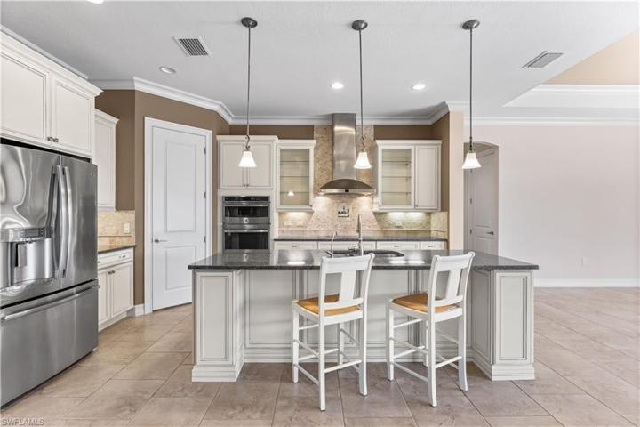 Open concept kitchen offers custom cabinetry, granite countertops, stainless steel appliances, oversized island!