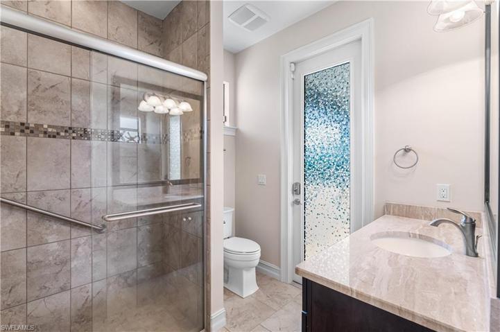This is the 3rd full bathroom with a walk in shower. Floor to ceiling tile. Single vanity. This is also a pool bath.