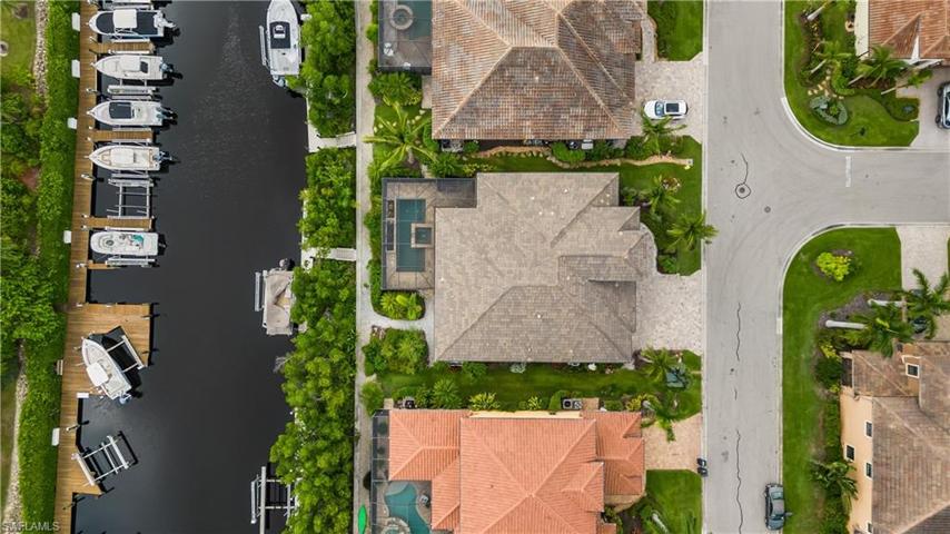 Great aerial view of the home, boat lift and canal.  Direct Gulf Access!