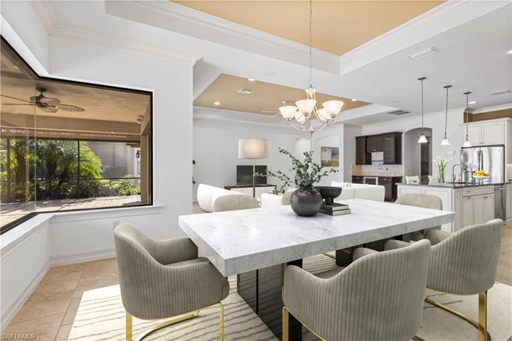 DINING AREA HAS SERENE VIEWS OF THE POOL AND LANAI. NEW INTERIOR PAINT. THIS ROOM HAS BEEN VIRTUALLY STAGED.