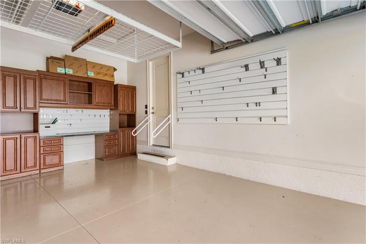 3 car garage is has a A/C split! Extra insulation as well. Storage above as well as the cabinetry.