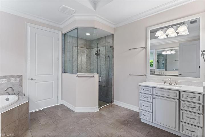Master ensuite bath also has a walk in shower, marble top vanities.