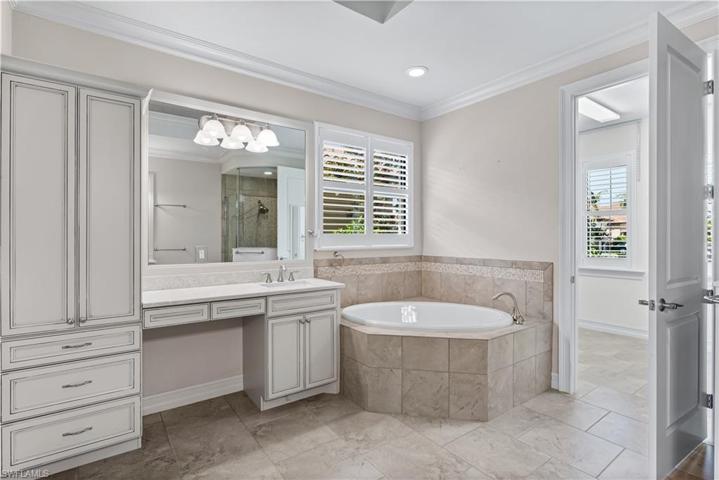 Master ensuite bathroom offers a separate soaking tub and a walk in shower( opposite side-see additional pictures) 2 separate vanities and dressing area. Storage area.  Huge walk in closet!