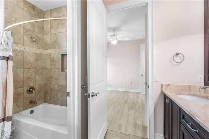 Jack and Jill bathroom has a shower/tub combination.