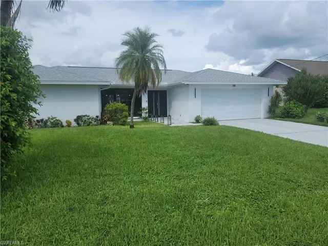 Ranch-style house featuring stucco siding, concrete driveway, a front lawn, and an attached garage